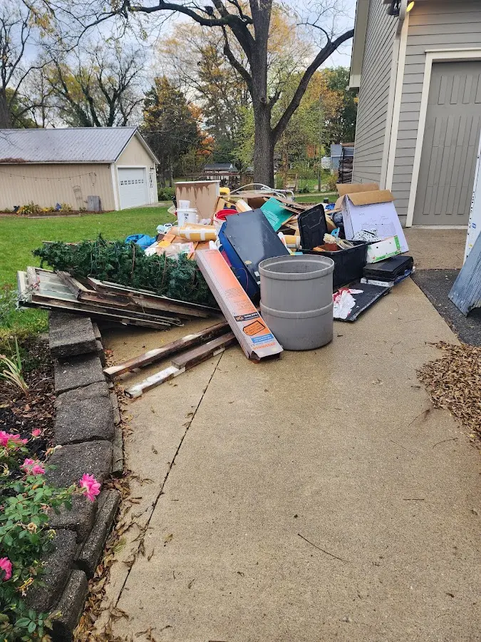 Dumpster being loaded with debris for 12 Yard Dumpster Rental in West Bloomfield